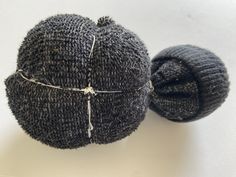 two balls of yarn sitting next to each other