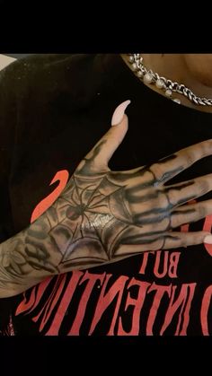 a person with tattoos on their arm and hand