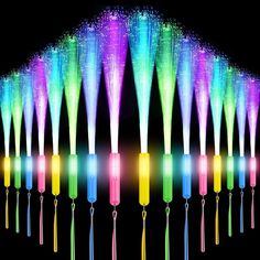 an array of different colored lights in the dark with long sticks sticking out of them