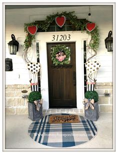 the front door is decorated with wreaths and decorations