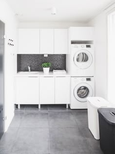 a washer and dryer in a white laundry room