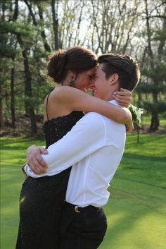 a man and woman hugging each other in front of some trees with the caption that reads