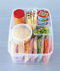 a plastic container filled with different types of food and condiments on top of it