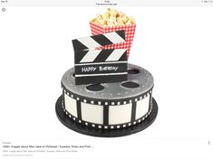 a birthday cake made to look like a movie clapper and popcorn