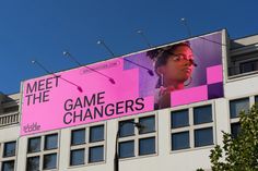 a large billboard on the side of a building advertising game changers in front of a blue sky