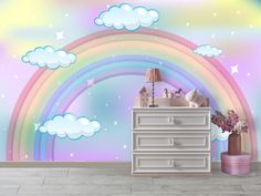 there is a dresser in front of a rainbow wall mural