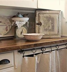 an old fashioned kitchen with dishes and utensils on the counter