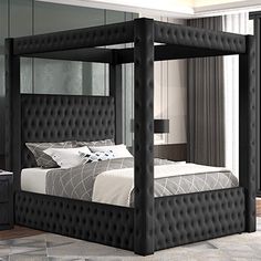 a bedroom with a four poster bed, nightstands and mirror on the wall next to it