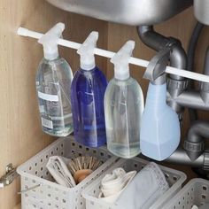 three bottles are sitting on the shelf under the faucet