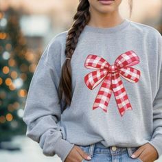 This cozy bow crewneck sweatshirt is perfect for chilly evenings or casual outings. Made from a soft cotton-polyester blend, it offers warmth and comfort with style. The cute bow design adds a playful touch, making it great for holiday gatherings or lounging at home. It fits well into the lives of anyone who enjoys a relaxed, stylish vibe, from moms to college students. Ideal for winter days or festive occasions, this sweatshirt is also a great gift that's sure to bring a smile. Product features Bow Sweater, Sweater Cute, Cute Bow, Holiday Sweater, Bow Design, Winter Days, Cozy Sweatshirts, Holiday Gathering, Cute Bows