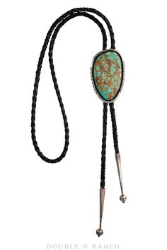 YOU WILL NOT REGRET THIS PURCHASE Big, bold, and beautiful are three words that describe this vintage Navajo bolo tie crafted by Will Denetdale. The bolo itself is a large, round turquoise stone set in a serrated bezel with a sterling silver border. Its color is a deep blue with large mineral deposits throughout the stone. It has a tension clamp on the back to keep it in place on the black braided bolo cord that has sterling silver aiguillettes on its ends. Bring big bold beauty to your style wi Collar Tips, Tie Crafts, Earring Pins, Bolo Tie, Three Words, Vintage Navajo, Black Braids, Bold And Beautiful, Scarf Jewelry