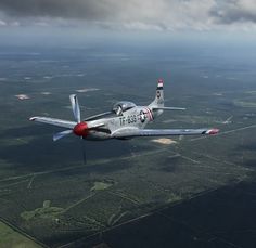 an airplane is flying in the sky over land