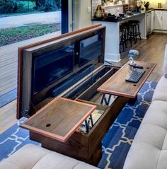 a living room filled with furniture and a flat screen tv on top of a coffee table