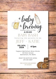 a baby is brewing party card with two mugs of beer on the front and bottom