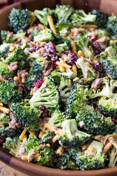 broccoli salad with cheese and cranberries in a bowl