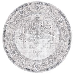 a round rug with an intricate design in grey and white colors, on a white background