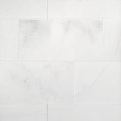 a white marble tile wall with no grouting