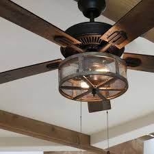 a ceiling fan that is hanging from the ceiling in a room with wood beams and white walls