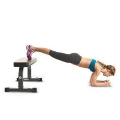 a woman is doing push ups on a bench