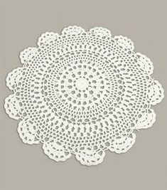 a white doily on a gray background