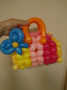 a person is holding balloons in the shape of flowers