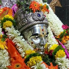 an idol is adorned with flowers and garlands