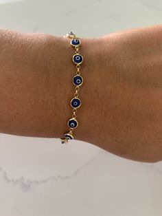 This 14K Gold Evil Eye Bracelet is an ideal accessory for daily wear, crafted from 14K solid gold with a glass blue eye. Make a lasting impression with the perfect gift for yourself or a loved one. The bracelet is available in a classic blue shade, delivering an iconic look. ♦ Materials: 14K Yellow God, Glass Blue Eye ♦ Available color: Blue evil eye ♦ Bracelet Measurements: Bracelet is 6 MM thick and 7.5" length, average weight 7.2grams, it does have a lobster clasp not a spring ring----------- Yellow Gold Round Evil Eye Bracelet, Hypoallergenic Gold Plated Blue Jewelry, Blue Gold-plated Tarnish-resistant Jewelry, Blue Hypoallergenic Round Bracelets, Hypoallergenic Blue Gold-plated Jewelry, Hypoallergenic Blue Round Bracelets, Blue Hypoallergenic Bracelets, Blue Tarnish-resistant Gold-plated Jewelry, 14k Gold Round Evil Eye Bracelets