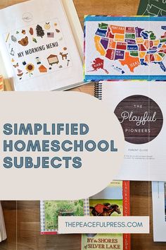 a table topped with lots of books on top of a wooden floor covered in pictures