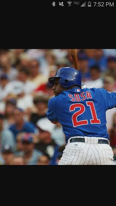 a baseball player holding a bat on top of a field in front of a crowd