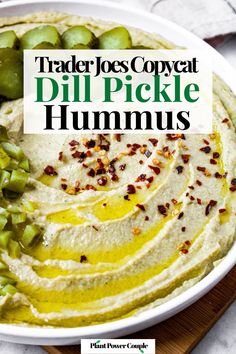 a white bowl filled with hummus and pickles