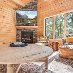 a living room with wood paneling and a fire place