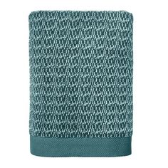 the teal and white towel is folded on top of a white surface with black trim