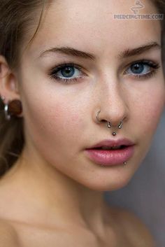 a young woman with piercings on her nose