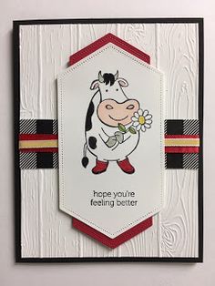 a card with a cow holding a flower