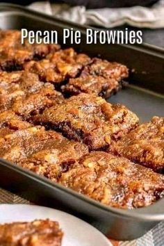 pecan pie brownies sitting in a pan on top of a table next to plates