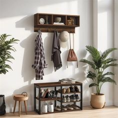 a coat rack with shoes and hats hanging on it next to a potted plant