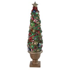 a small christmas tree is sitting in a vase with ornaments on the top and bottom