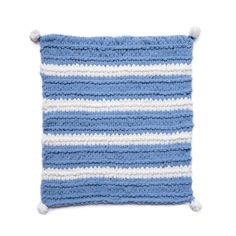 a blue and white crocheted pillow with pom poms on the bottom