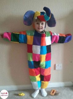 a child in a clown costume standing on the floor