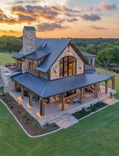 an aerial view of a house with a stone and metal roof