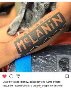 a man's arm with the word melanin tattooed on it