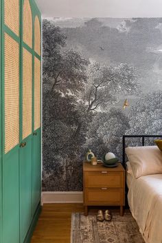 a bedroom with a green door and wallpaper