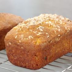 two muffins sitting on top of a cooling rack