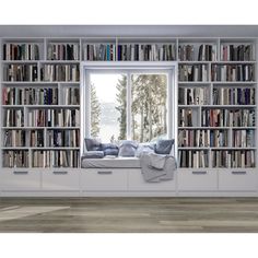 a window seat in front of a bookshelf filled with lots of books and pillows