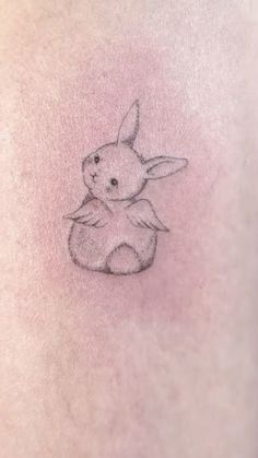 a small rabbit tattoo on the stomach