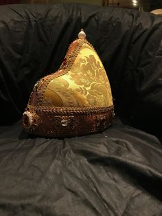 The Doge Hat is the headdress worn by the Doges of Venice and carried over a white cap, similar to the papal camauro, an annual gift of the nuns of San Zaccaria. Composed of a circular crown and a pointed cap in the back, the ducal horn resembled the Phrygian cap worn by Byzantine soldiers and the Venetian dux in ancient times. It was carried, but in a smaller form than that of the Doge, also to crown the golden veil of the Dogaressa, his consort. Over time the various ducal horns have been embe Traditional Costume Hat With Structured Crown, Vintage Ceremonial Costume Hat With High Crown, Ceremonial Costume Hat With Structured Crown, Traditional Handmade Costume Hats And Headpieces, Adjustable Ceremonial Costume Hat With Structured Crown, Traditional Ceremonial Headpiece With Pinched Crown, Traditional Festival Costume Headpieces, Ceremonial Tall Crown Headpiece For Festivals, Traditional Headpieces For Costume Festivals