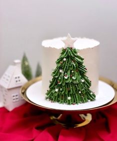 a small christmas tree on top of a white cake