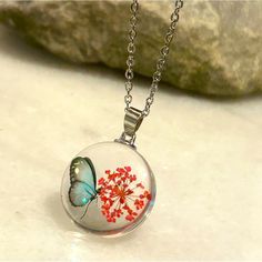 Red Floral Butterfly Clear Pendant Necklace This Beautiful Large Pendant Is Wonderfully Crafted. Comes On A 50cm/20in Stainless Steel Chain. Christmas Resin, Floral Butterfly, Resin Necklace, Fantasy Jewelry, Butterfly Necklace, Steel Chain, Stainless Steel Chain, Resin Jewelry, Resin Crafts