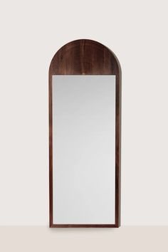 a wooden mirror sitting on top of a table