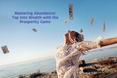 a woman is throwing money into the air with her arms in the air while standing on a beach